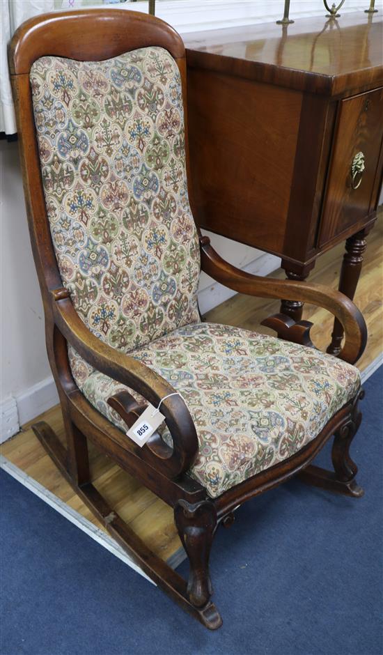 A Victorian mahogany upholstered rocking chair